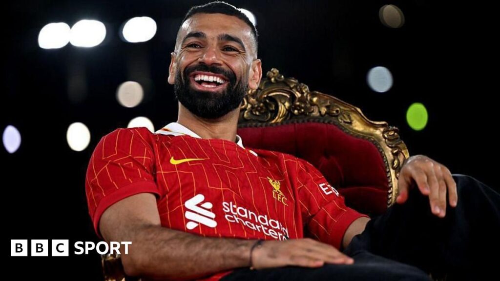Egypt fans at the 2019 Africa Cup of Nations hold up a banner showing the face of forward Mohamed Salah