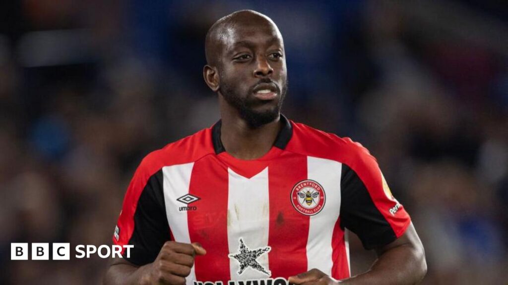 Yoane Wissa in a red and white striped Brentford match shirt