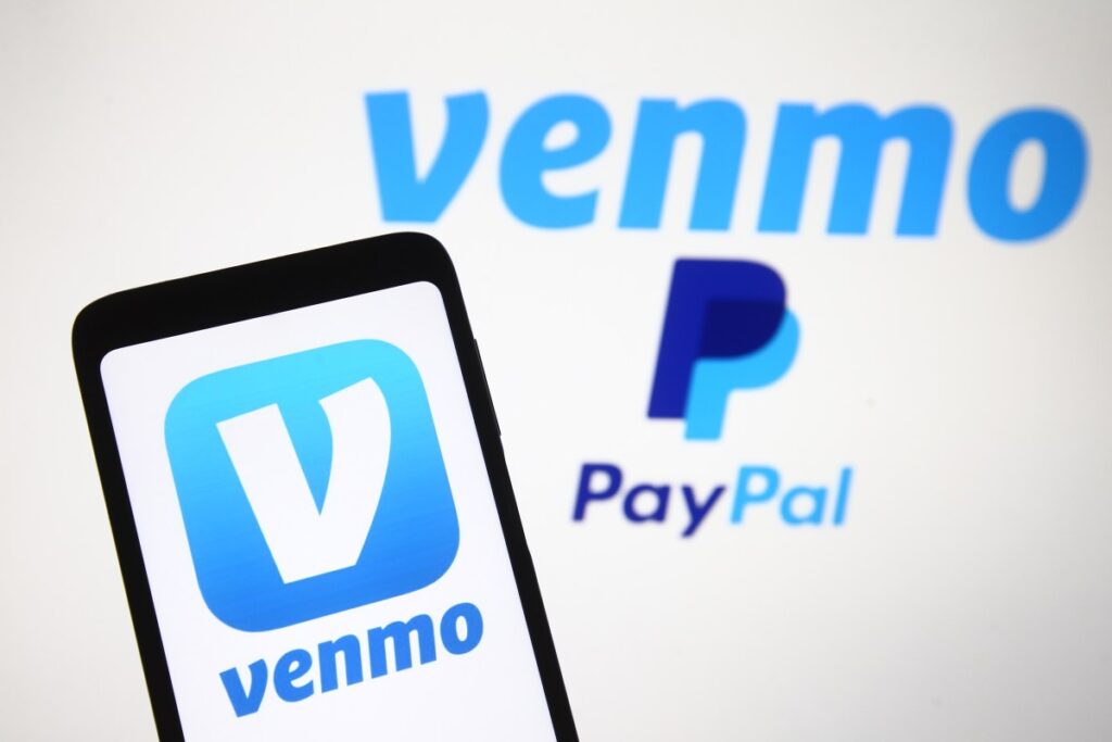 PayPal partners with OpenAI to let users pay for their shopping within ChatGPT Venmo logo, a mobile payment service of PayPal is seen displayed on a smartphone and a PC screen.